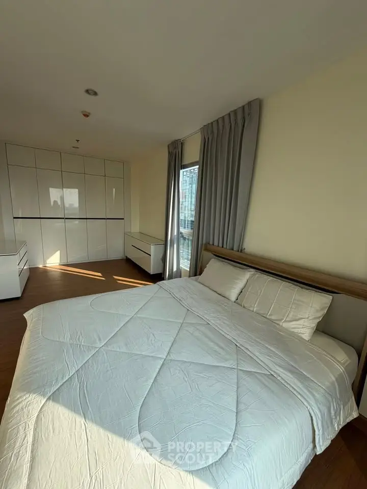 Spacious bedroom with modern design and ample natural light