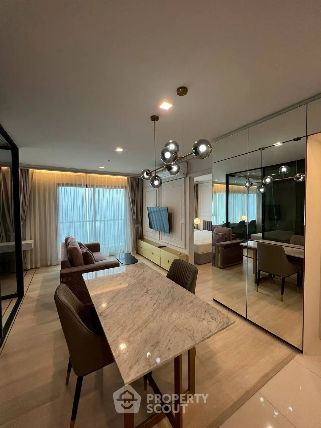 Modern living room with elegant dining area and stylish lighting in a luxurious apartment.
