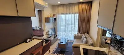 Modern living room with city view, stylish furniture, and cozy ambiance.