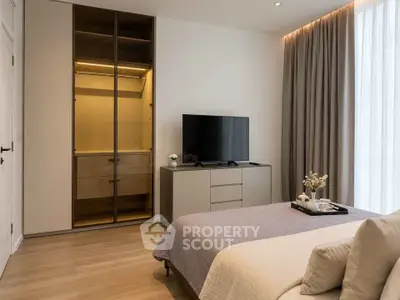 Modern bedroom with sleek wardrobe and cozy decor