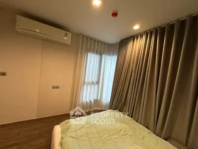 Cozy bedroom with modern air conditioning and elegant curtains