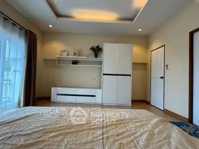 Spacious bedroom with modern furniture and natural light