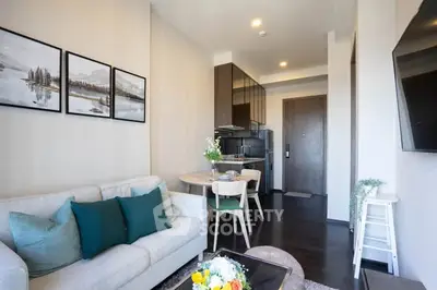 Modern living room with stylish decor and open kitchen layout in a cozy apartment.