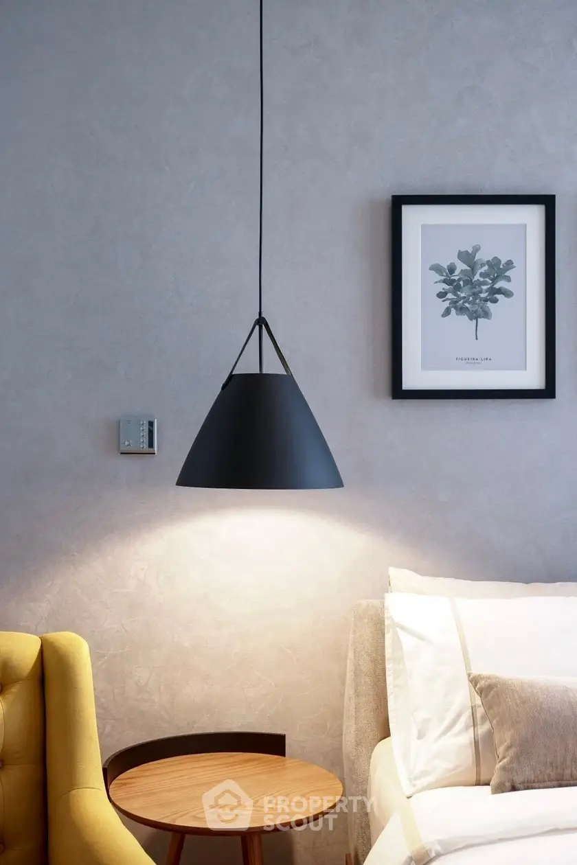 Modern bedroom with stylish pendant light and cozy decor
