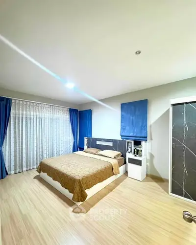 Spacious modern bedroom with elegant decor and natural light