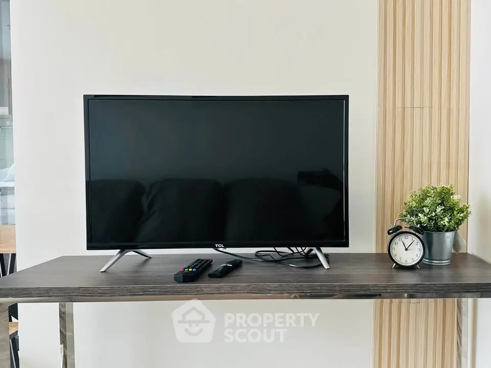 Modern living room with sleek TV setup on stylish wooden console, perfect for entertainment.