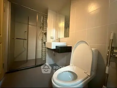Modern bathroom with glass shower and sleek fixtures in a contemporary home.
