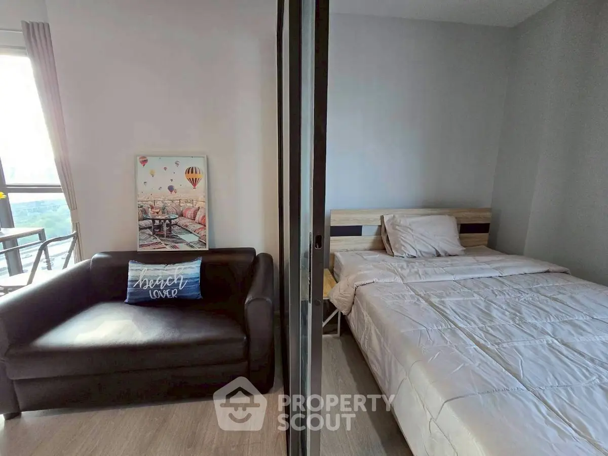 Cozy bedroom with modern decor and natural light, perfect for relaxation.