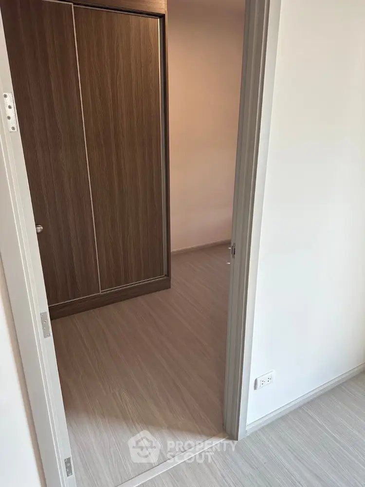 Modern apartment interior with wood flooring and built-in closet