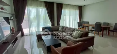 Spacious living room with modern furniture and large windows offering natural light.