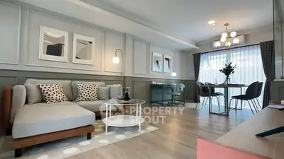 Modern living room with stylish decor and dining area, featuring elegant lighting and contemporary furniture.