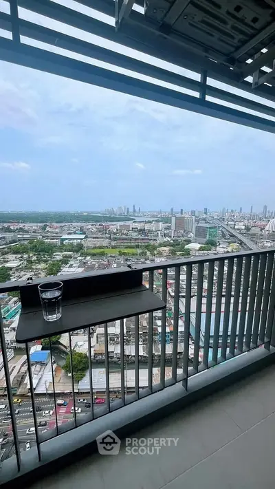 Stunning high-rise balcony with panoramic city views and sleek railing design.