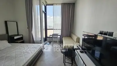 Modern bedroom with city view, featuring sleek furniture and natural light.