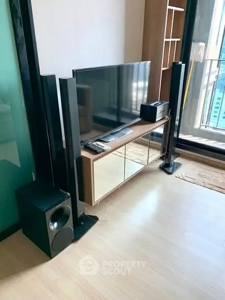 Modern living room with sleek entertainment setup and balcony view