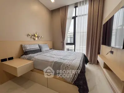 Modern bedroom with stylish decor and large window for natural light