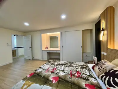 Spacious bedroom with modern decor and ample natural light