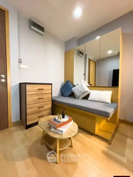 Cozy study nook with modern furniture and stylish decor in a well-lit room.