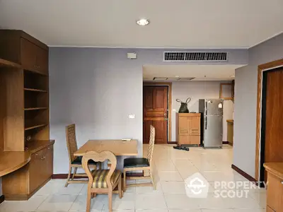 Spacious dining area with wooden furniture and modern kitchen appliances in a cozy apartment.