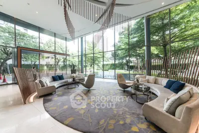Luxurious modern living room with floor-to-ceiling windows and elegant curved sofas.