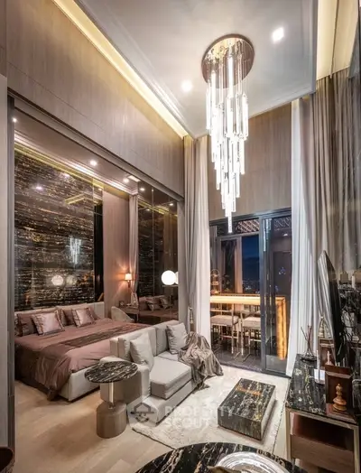Luxurious modern bedroom with high ceiling and elegant chandelier, featuring a cozy seating area and stylish decor.