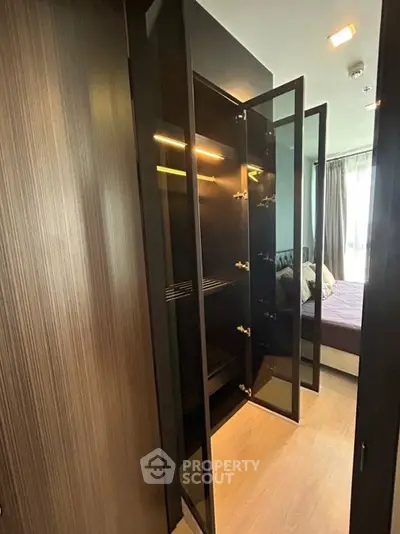 Modern bedroom with sleek open wardrobe and natural light