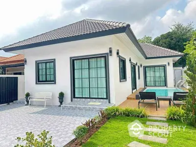 Charming single-story house with pool and landscaped garden, perfect for modern living.