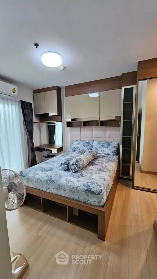 Cozy bedroom with modern decor and ample natural light, featuring a stylish bed and built-in storage solutions.