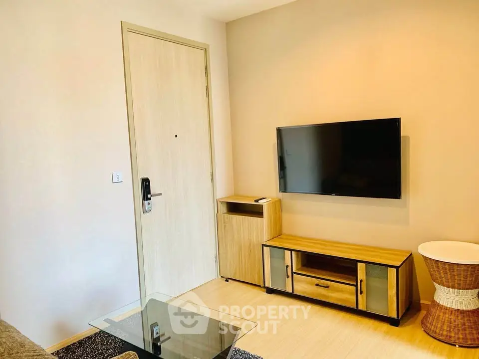 Modern living room with wall-mounted TV and stylish wooden furniture.