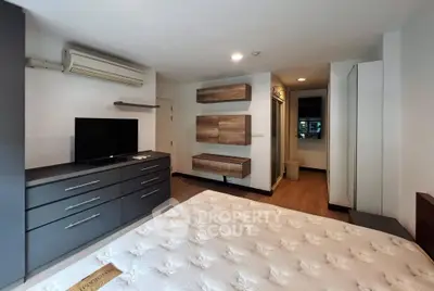 Modern bedroom with sleek furniture and air conditioning in a stylish apartment.