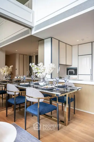 Luxurious modern dining area with elegant table setting and stylish kitchen in open layout.
