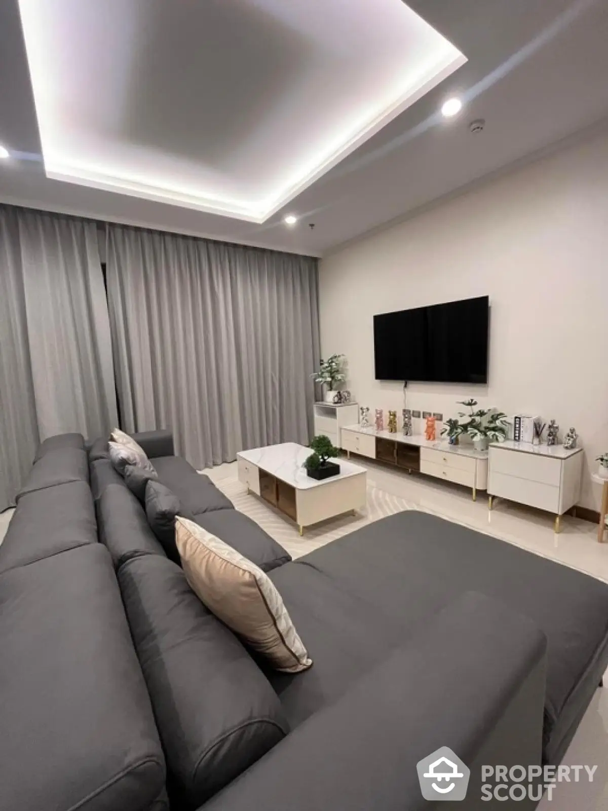 Luxurious modern living room with sleek gray sofa and elegant decor