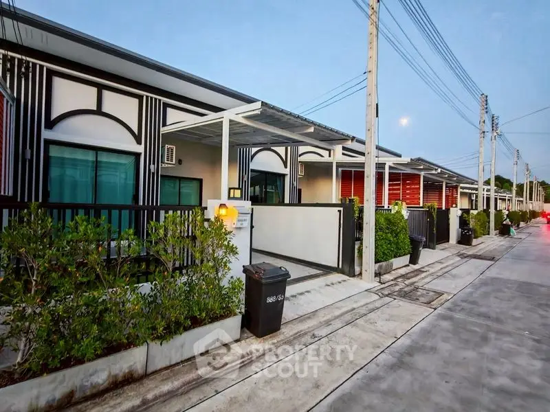 Modern row of townhouses with sleek design and lush greenery