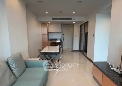 Modern open-plan living and dining area with sleek furniture and polished floors.