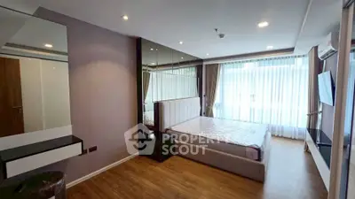 Spacious modern bedroom with large windows and stylish decor