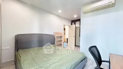 Modern bedroom with stylish furniture and air conditioning in a contemporary apartment.