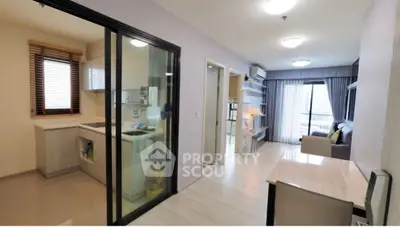 Modern apartment interior with open layout, featuring a cozy living room and sleek kitchen design.