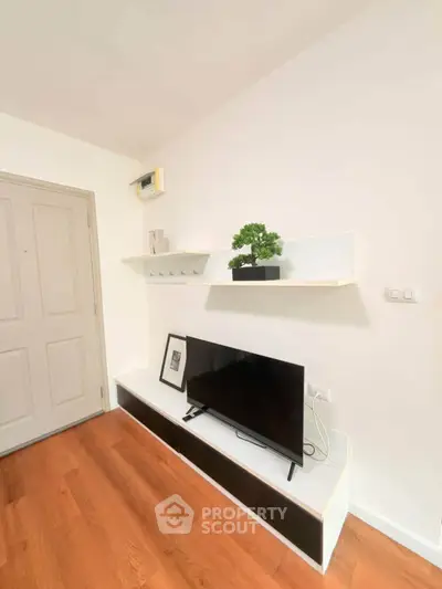 Modern living room with sleek TV setup and stylish wooden flooring