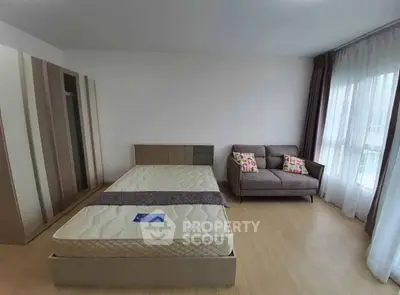 Spacious bedroom with modern decor and natural light