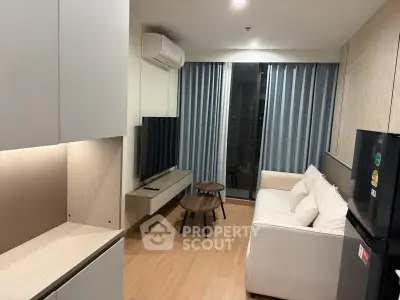 Modern living room with sleek furniture and balcony view in a stylish apartment.