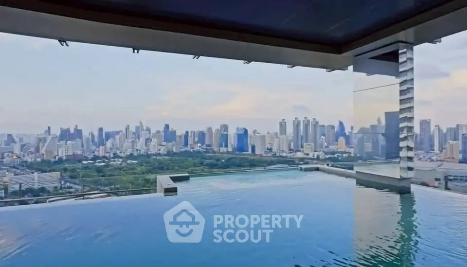 Luxurious rooftop infinity pool with stunning city skyline view, perfect for urban living enthusiasts.