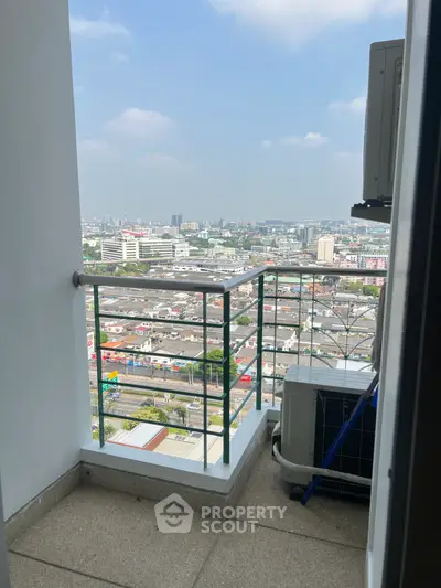 Stunning cityscape view from a high-rise balcony with clear skies.
