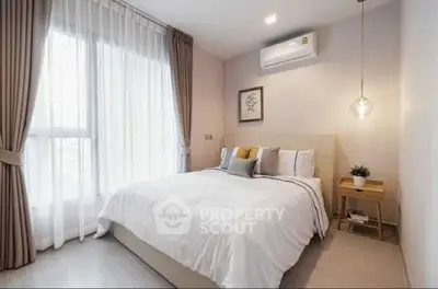 Modern bedroom with elegant decor, featuring a cozy bed, stylish lighting, and large window with curtains.