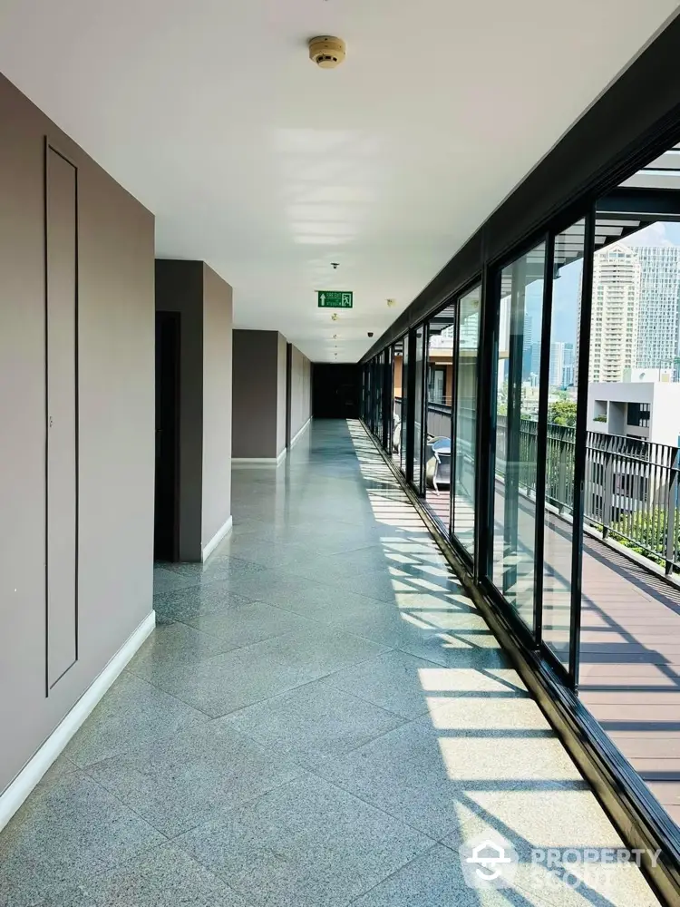 Spacious modern corridor with large windows and city view