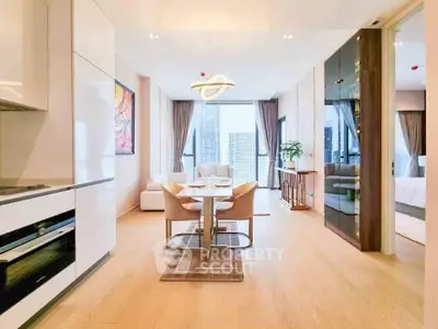 Luxurious open-plan living room with modern kitchen and elegant dining area in high-rise apartment.
