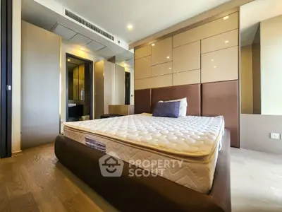 Luxurious modern bedroom with stylish design and plush mattress in upscale apartment.