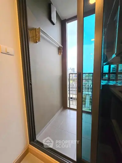 Modern apartment balcony with city view and sliding glass door