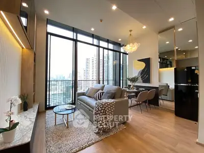 Luxurious modern living room with floor-to-ceiling windows and city view.