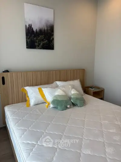 Cozy bedroom with modern decor and comfortable bedding in a stylish apartment.