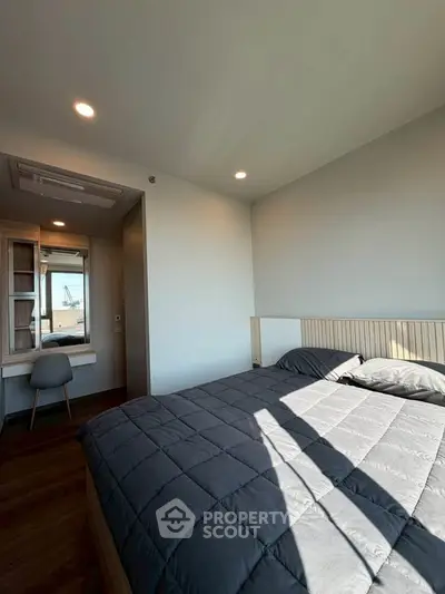 Modern bedroom with stylish decor and ample natural light
