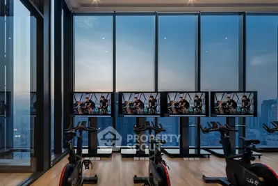 Luxurious high-rise gym with panoramic city views and modern exercise equipment.